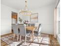 Bright dining room features a modern chandelier and a stylish rug, creating an inviting atmosphere at 1115 Ross Brook Trce, York, SC 29745