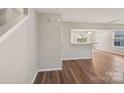 Bright living room with laminate wood floors and an open layout to the adjacent kitchen area at 12218 Stewarts Crossing Dr, Charlotte, NC 28215