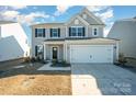 Attractive two-story home with attached two-car garage and manicured lawn at 1433 Harleston St, Indian Trail, NC 28079