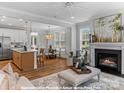 Inviting open-concept living space featuring a modern kitchen, dining area, and cozy living room with a fireplace at 272 Gilead Rd, Huntersville, NC 28078