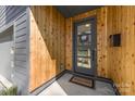 Stylish front entrance with cedar accents and a modern gray door with glass panels at 3132 Carol Ave, Charlotte, NC 28208