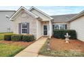 Inviting entryway with neatly landscaped shrubbery and a cute pineapple statue at 3134 Sterling Ct, Fort Mill, SC 29707