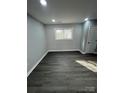 Bright bedroom with gray walls, wood-look floors, and a window offering natural light at 317 Echodale Dr, Charlotte, NC 28217