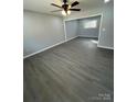 Spacious living room featuring gray walls, wood-look floors, and a ceiling fan at 317 Echodale Dr, Charlotte, NC 28217