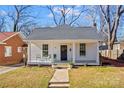 Charming white home featuring a cozy front porch with classic columns and a walkway leading to the entrance at 506 S Church St, Salisbury, NC 28144