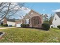 A charming brick home with well-kept grounds and a view of neighboring houses on a sunny day at 529 Veloce Trl, Fort Mill, SC 29715