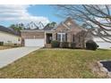 Beautiful brick home with a well-maintained lawn and stylish dormer windows above the garage at 529 Veloce Trl, Fort Mill, SC 29715