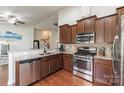 Well-equipped kitchen with stainless steel appliances, granite countertops, and ample cabinet space for storage at 5826 Castlecove Rd, Charlotte, NC 28273