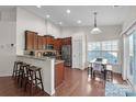 Bright eat-in kitchen features granite counters, stainless appliances, and wood cabinets, perfect for cooking and gathering at 5826 Castlecove Rd, Charlotte, NC 28273