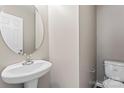 Small half bathroom with pedestal sink and toilet at 5851 Brookfield Pointe Dr, Charlotte, NC 28216