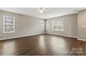 Spacious living area with dark laminate floors and lots of natural light at 5851 Brookfield Pointe Dr, Charlotte, NC 28216