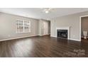 Living room featuring a fireplace and dark laminate floors at 5851 Brookfield Pointe Dr, Charlotte, NC 28216