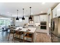 Modern kitchen with white cabinets, quartz countertops and island with seating at 6911 Fauna Dr # 60, Charlotte, NC 28215