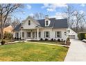 White house with gray shutters, landscaping, and a long driveway at 835 Museum Dr, Charlotte, NC 28207