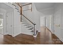 Elegant hardwood staircase with white railings in a bright foyer at 835 Museum Dr, Charlotte, NC 28207