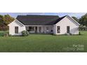 This home has a beautiful rear view, showcasing an idyllic setting for relaxation and outdoor enjoyment at 000 Ridgecrest Rd # 10, Locust, NC 28097