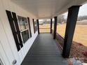Covered front porch offers a relaxing space with black railings and gray decking at 106 Gilliatt St, Shelby, NC 28150