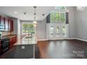 Bright kitchen with stainless steel appliances, granite countertops, and double-height ceilings with lots of light at 128 Steinbeck Way # E, Mooresville, NC 28117