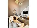 Comfortable living room featuring high ceilings, plush seating, and stylish decor at 128 Steinbeck Way # E, Mooresville, NC 28117
