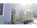 Inviting front porch with wooden railings and steps at 1407 7Th St, Statesville, NC 28677