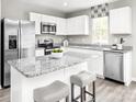 Modern kitchen with white cabinets, granite countertops, and stainless steel appliances at 1525 39Th Avenue Ne Loop # 2, Hickory, NC 28601