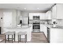 Modern kitchen with white cabinets, granite island, and stainless steel appliances at 1525 39Th Avenue Ne Loop # 2, Hickory, NC 28601