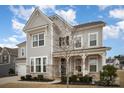 Two-story house with gray siding, stone accents, and a front porch at 15421 Keyes Meadow Way, Huntersville, NC 28078