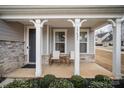Front porch with rocking chairs and a view of the neighborhood at 15421 Keyes Meadow Way, Huntersville, NC 28078