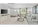 Living room with gray sofa, white coffee table, and neutral decor at 324 Maplestead St # 1077, Lancaster, SC 29720