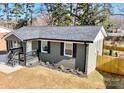 Side view of a renovated house with gray brick and modern updates at 4513 Munsee St, Charlotte, NC 28213