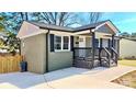 Charming house featuring a covered porch, modern paint, and new concrete sidewalk at 4513 Munsee St, Charlotte, NC 28213