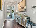 Bright and spacious entryway with hardwood floors and decorative console at 4998 Looking Glass Trl, Denver, NC 28037