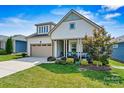 Two-story home with light-colored siding and a charming porch at 4998 Looking Glass Trl, Denver, NC 28037