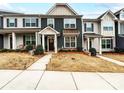 Townhouse featuring a well-maintained front lawn and appealing architectural design at 1108 Township Pkwy, Belmont, NC 28012