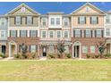 New townhomes with brick and siding exteriors, manicured lawns, and professional landscaping create inviting curb appeal at 114 Marron Dr, Indian Trail, NC 28079