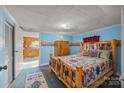 Cozy bedroom featuring a log bed frame and southwestern decor at 11745 Stokes Ferry Rd, Gold Hill, NC 28071