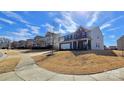 Two-story home with brick and siding, complemented by a well-maintained lawn and blue skies at 121 Mackinac Dr, Mooresville, NC 28117