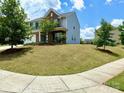 The house is a 2-story home with vinyl siding, brick accents, and a large lawn at 121 Mackinac Dr, Mooresville, NC 28117