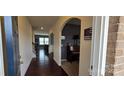 Inviting foyer with hardwood floors, arched doorways, and view into the living area at 121 Mackinac Dr, Mooresville, NC 28117