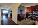 Cozy living room featuring hardwood floors, arched doorway, and neutral paint at 121 Mackinac Dr, Mooresville, NC 28117