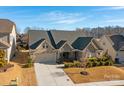 Aerial view of a brick house with a large backyard and surrounding homes at 12904 Vermillion Xing, Huntersville, NC 28078