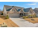 Brick front house with 2-car garage and landscaping at 12904 Vermillion Xing, Huntersville, NC 28078