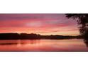 Stunning sunset over the lake with colorful sky at 168 Tanglewood Cv, Belmont, NC 28012