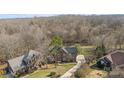 An aerial view of the house on a large lot surrounded by mature trees at 2050 Stoney Creek Nw Dr, Concord, NC 28027