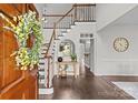 Two-story foyer with hardwood floors and a staircase at 2050 Stoney Creek Nw Dr, Concord, NC 28027