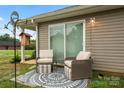 Relaxing back patio with wicker chairs and patterned rug at 209 S Gregory St, Lancaster, SC 29720