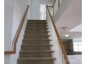 Carpeted staircase with white railing and wood trim, leading to the upper level at 2327 Axford Ln, Matthews, NC 28105