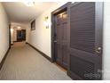 Hallway entrance showcases a neutral color scheme, clean design, and unit number, offering simple navigation at 2501 Roswell Ave # 303, Charlotte, NC 28209