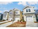 Charming townhomes featuring attached garages and welcoming curb appeal with manicured landscaping under a bright sky at 252 Laura Elizabeth Ln, Clover, SC 29710