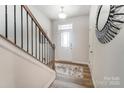 Inviting entryway with wood floors, staircase, and a stylish decorative mirror at 268 Laura Elizabeth Ln, Clover, SC 29710